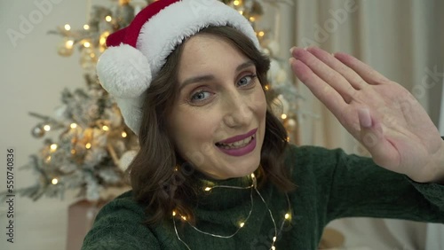 woman calls her friends via video conference call wishing Merry Christmas