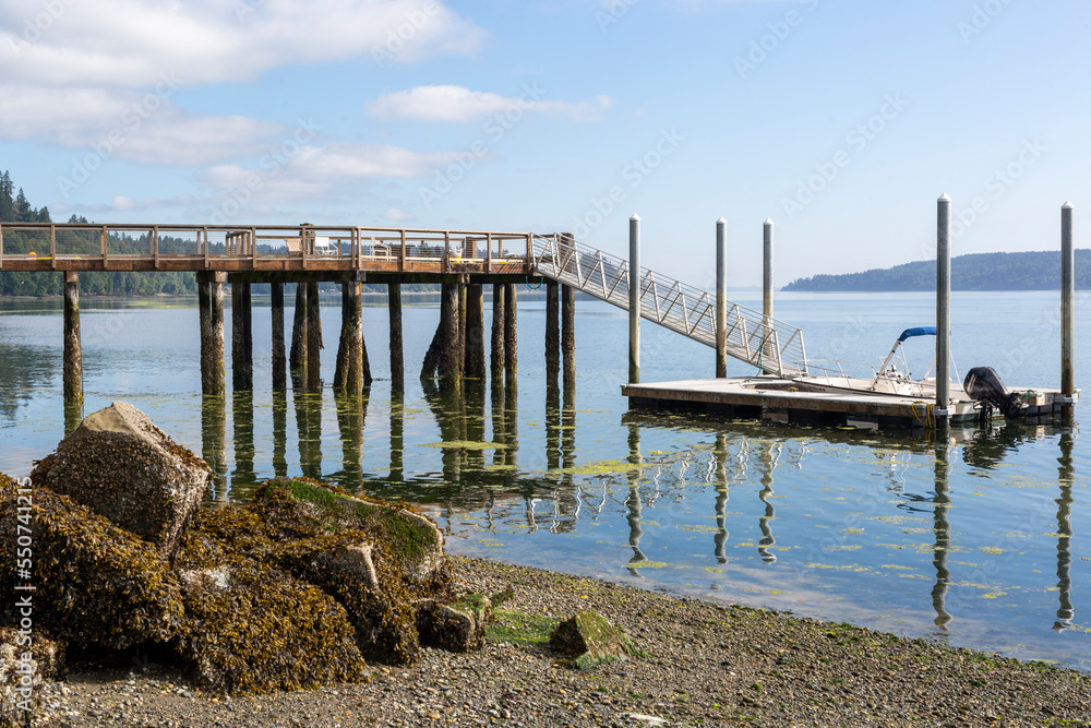 boat parked on a pier in the bay against the backdrop of mountains