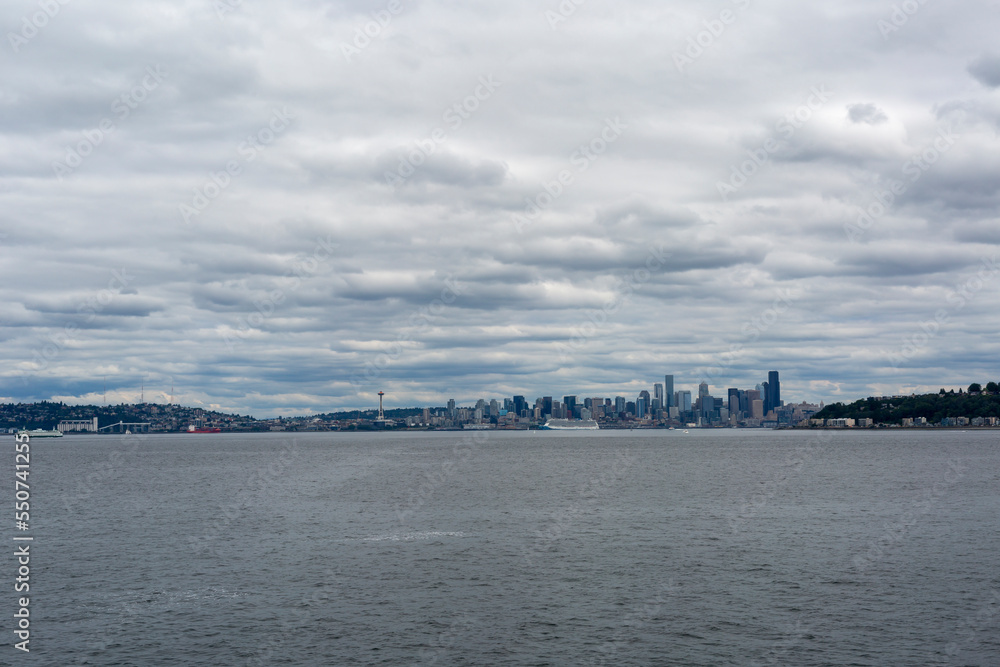 view of the city of Seattle from the water with the sky in the clouds