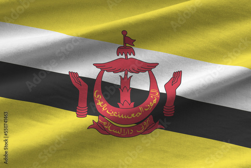 Brunei Darussalam flag with big folds waving close up under the studio light indoors. The official symbols and colors in fabric banner photo