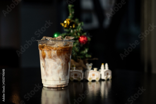 ice latte coffee in plastic glass on black table at cafe   