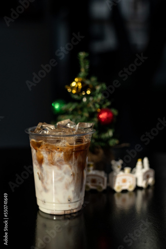 ice latte coffee in plastic glass on black table at cafe   