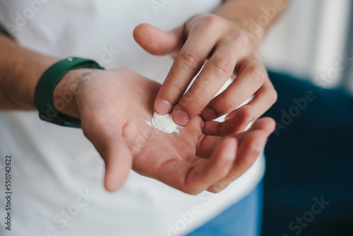 Close-up man's hands rubbing cream in the palm of his hand. Health concept. Love people concept. Medical health. Skin care. Natural beauty. Body care.
