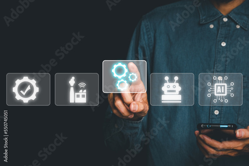 Automation business technology concept, Person hand poiting gear with automation technology icon on VR screen, software development, Business process and technology.