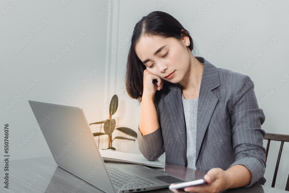 Tired businesswoman sleeping on table in office. Young exhausted girl working from home. Woman using laptop. Entrepreneur, business, freelance work, student, stress, work from home concept Tired businesswoman sleeping on table in office. Young exhausted girl working from home. Woman using laptop. Entrepreneur, business, freelance work, student, stress, work from home concept