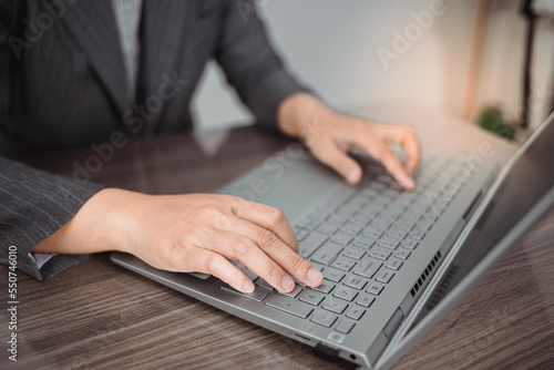 business woman looking the laptop or Notebook computer, personal working with laptop in the home office.