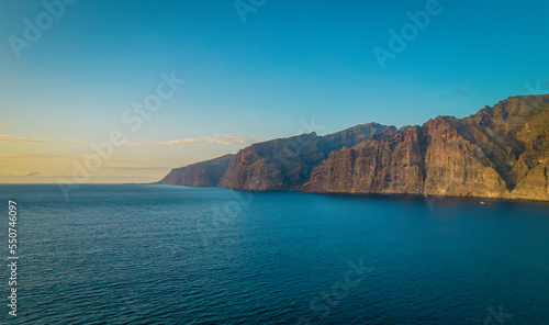 Aerial drone photo of Los Gigantes cliffs during a sunset in Tenerife, Canary Islands. 
