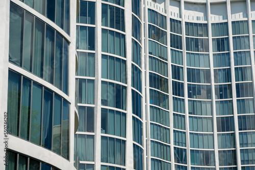Close-up of a modern building exterior with curved walls with tall glass windows in Miami, Florida © Jason