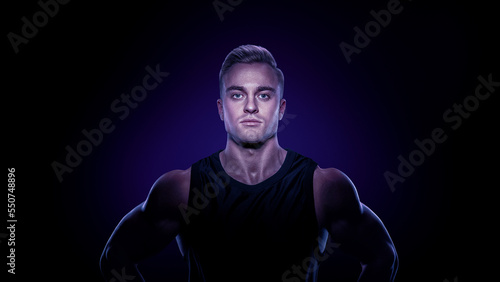 Portrait of Confident muscular bodybuilder. Dramatic light. Power and strong concept. Caucasian fitness male model with muscular neck and shoulders. © USM Photography