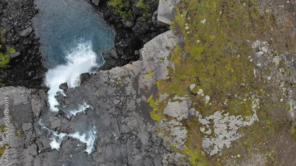 Aerial of Gufufoss waterfall in Iceland birdseye view, clear blue water Aerial of Gufufoss waterfall in Iceland birdseye view, clear blue water