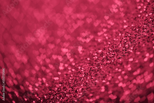 Red Viva Magenta glitter background with hearts bokeh for Valentines day.