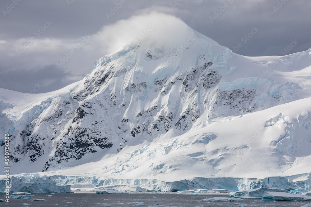 A mountain in Antarctica covered in snow on a bright summer day