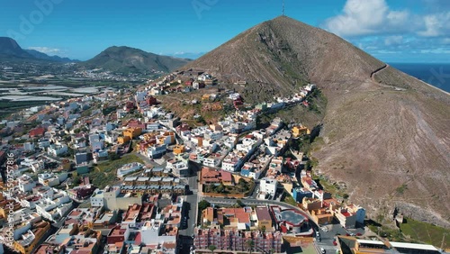 Cinematic aerial shot in orbit over the city of Galdar and the Galdar mountain. On a sunny day on the island of Gran Canaria, Spain. photo
