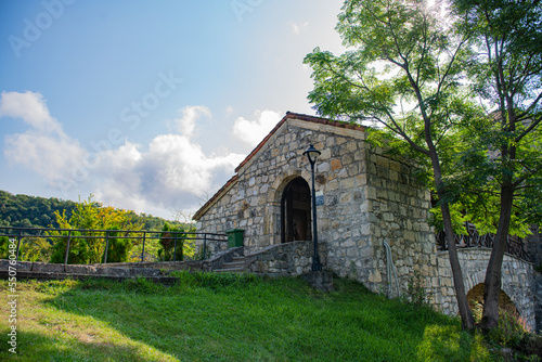 stone structure with door lantern green grass olac sky
