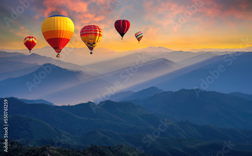 Colorful hot air balloons flying above high mountain at sunrise with beautiful sky background. aerial from Doi Pui Co, Mae Hong Son in Thailand