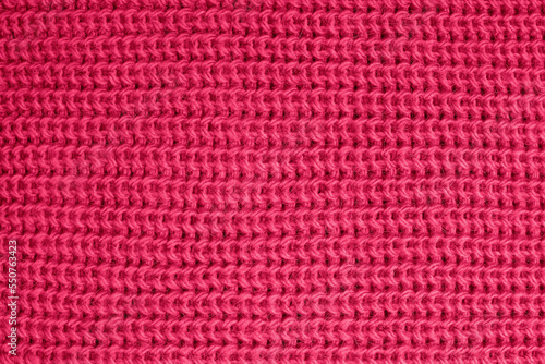 Knitted texture of vivid magenta color close-up