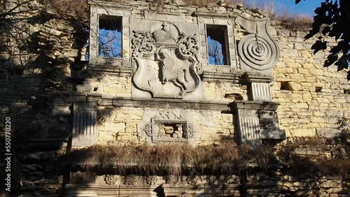 Medieval entrance tower of Chernelytsia Castle, Ivano-Frankivsk region, Ukraine. The front facade is decorated with historical coat of arms. photo