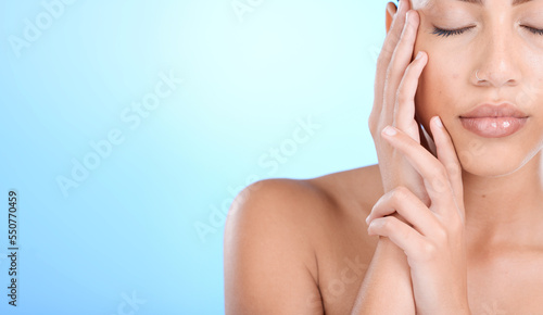 Cosmetic  skincare and beauty of a woman holding her healthy face ready for wellness and skin treatment. Calm female model from Mexico touching smooth body texture with dermatology in blue background