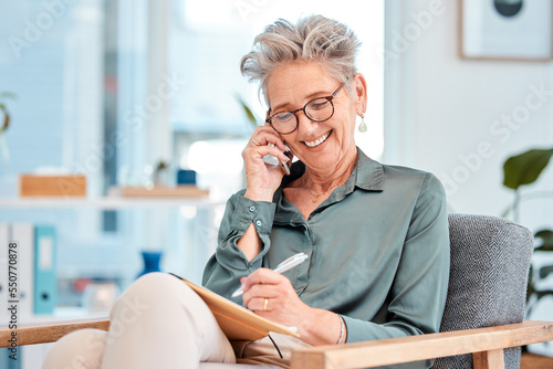 Phone call, writing and schedule with a female leader, manager or CEO talking while making an appointment in her notebook. Mobile, communication and diary with a senior business woman writing notes photo