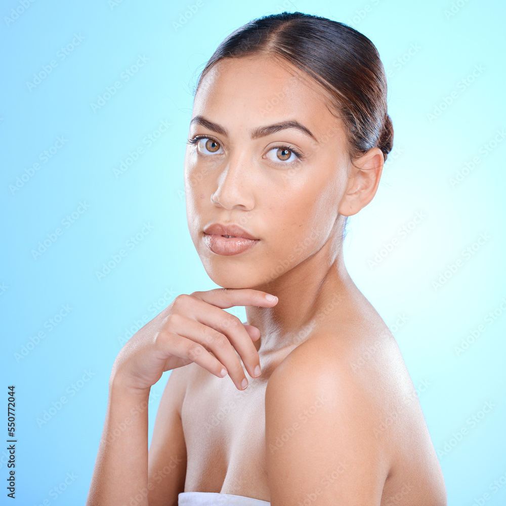 Woman, beauty and face skincare, makeup and clean skin for health and wellness in blue studio background. Dermatology, natural and young female model, facial cosmetics and healthy glow or self care Woman, beauty and face skincare, makeup and clean skin for health and wellness in blue studio background. Dermatology, natural and young female model, facial cosmetics and healthy glow or self care
