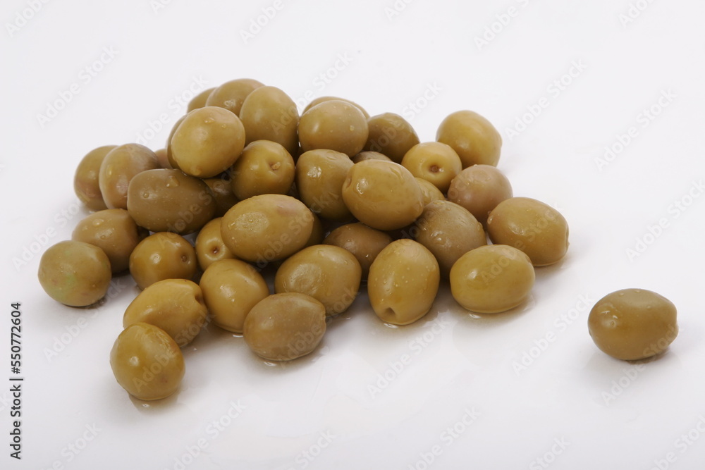 Fresh wet olives on a white surface Fresh wet olives on a white surface