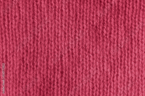Trendy color of 2023 viva magenta. texture of knitted angora fabric. magenta wool texture. Knitted jersey background with relief pattern for wallpaper and abstract background. handmade