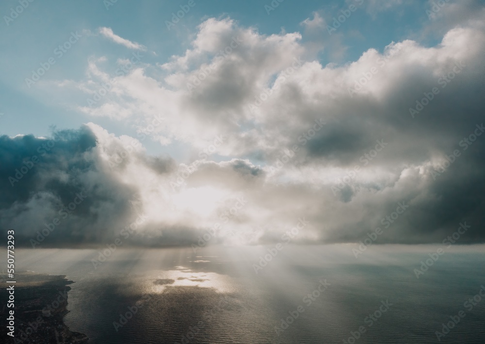 Aerial view. The drone flies over foggy and fluffy clouds. Blue sky sun and sea fog. Abstract aerial nature summer ocean sunset sea and sky background. Horizon. Vacation, travel and holiday concept Aerial view. The drone flies over foggy and fluffy clouds. Blue sky sun and sea fog. Abstract aerial nature summer ocean sunset sea and sky background. Horizon. Vacation, travel and holiday concept
