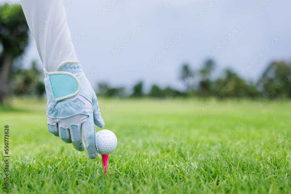 professional golfer hold golf ball put on tee by glove golf at green