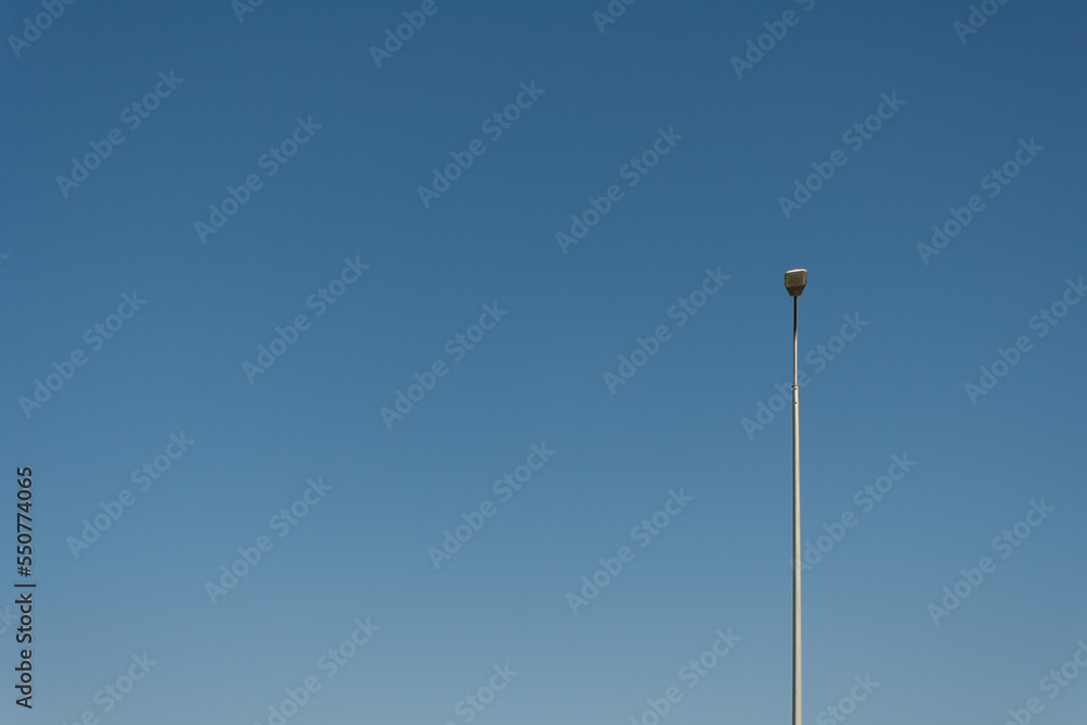 a lonely lamppost against the blue sky, a place to copy