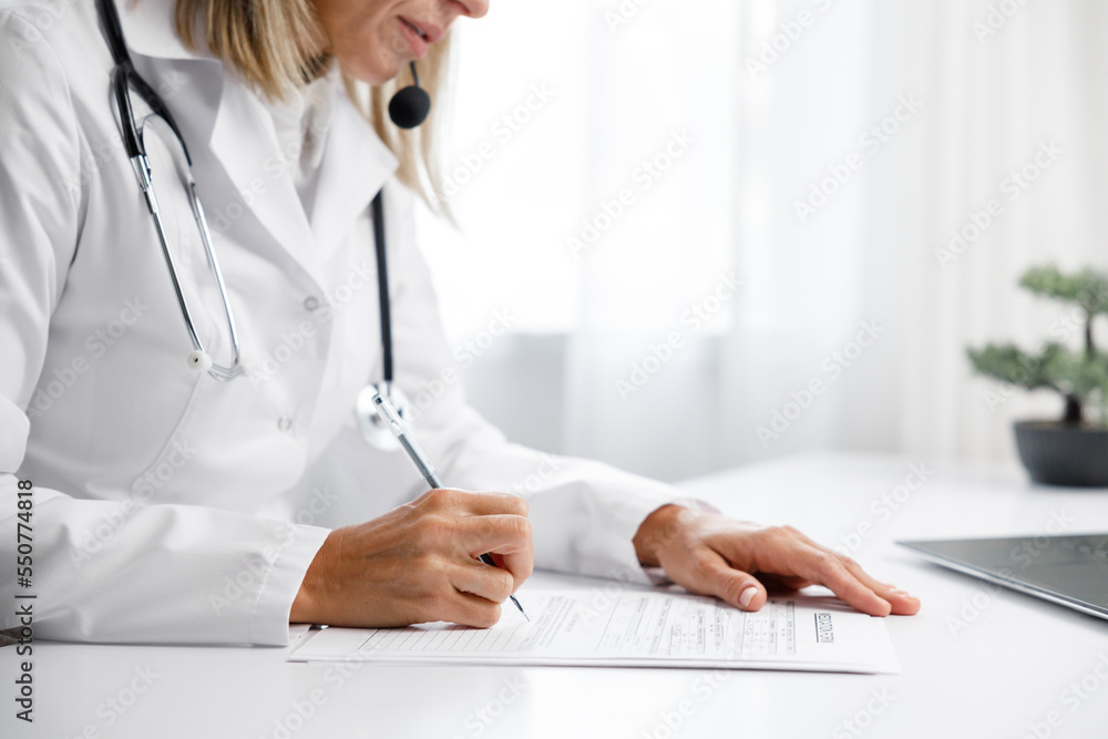 Woman medic, doctor writes out a prescription. Makes an entry in the medical record. Medical background. Woman medic, doctor writes out a prescription. Makes an entry in the medical record. Medical background.