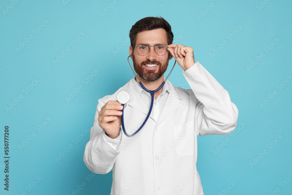 Doctor with stethoscope on light blue background Doctor with stethoscope on light blue background