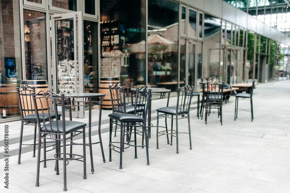 Beautiful cafe with dark stylish furniture outdoors