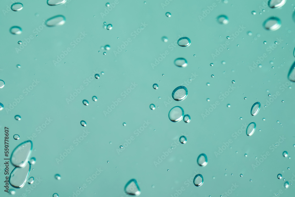 Serum drops on light blue background, closeup