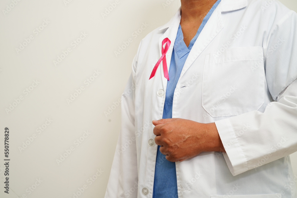 Asian woman doctor with pink ribbon, World Breast Cancer Day at October. Asian woman doctor with pink ribbon, World Breast Cancer Day at October.