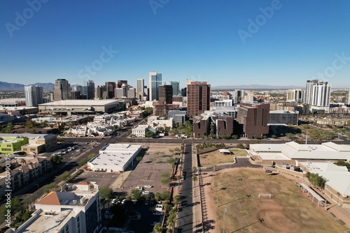 Aerial view of the cityscape on a sunny day with a blue sky in the background photo