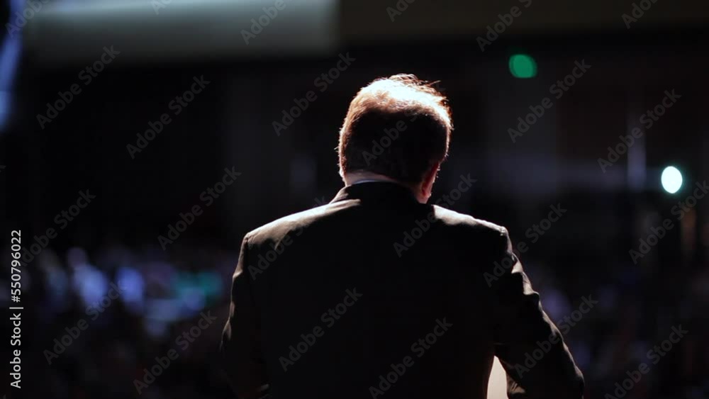 Back of person giving a speech. Man talking in front of audience Back of person giving a speech. Man talking in front of audience