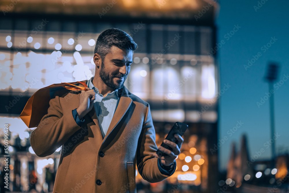 © ivanko80 - Man in shopping,using phone