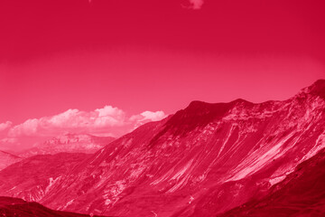Acrylglasbilder Pantone 2023 Viva Magenta Beautiful sunny day in mountain valley and mountainous countryside landscape in summer. Image toned in color of year 2023 Viva Magenta. Mountain range under cloud sky.  © sommersby