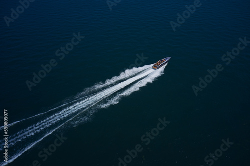 Gray boat fast movement on the surface of the sea. Aerial view of a luxury speedboat on a blue sea on a sunny day