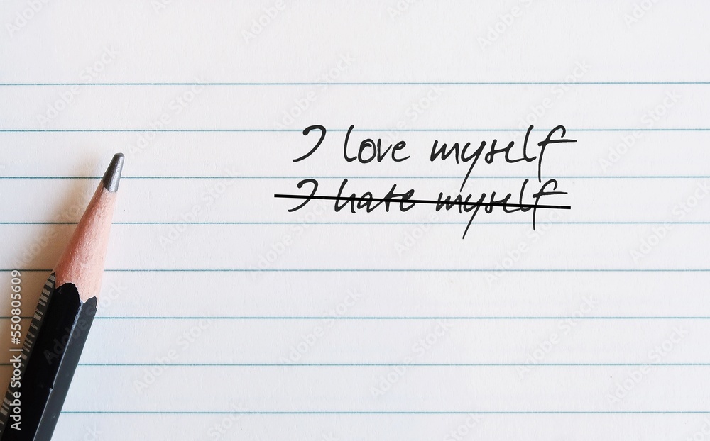 Pencil on note paper with handwritten text I HATE MYSELF, change to I LOVE MYSELF, concept of overcoming self-hatred feeling and focus on positivity, boost self worth for healthy mentality Pencil on note paper with handwritten text I HATE MYSELF, change to I LOVE MYSELF, concept of overcoming self-hatred feeling and focus on positivity, boost self worth for healthy mentality