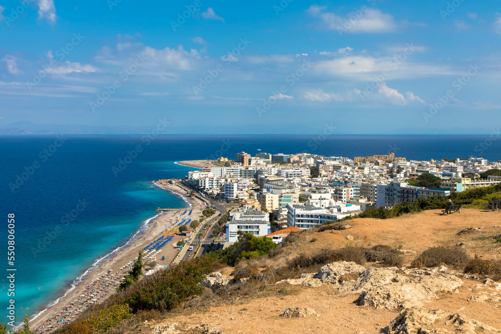 Aerial view  of Rhodes city island with skycrapers and the famous Elli Beach. Panorama with nice sand, lagoon and clear blue water. Famous tourist destination in South Europe. Rhodes Island, Greece.