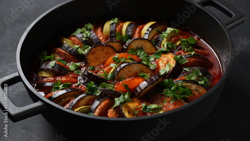 Tableau sur toile Layered ratatouille in a baking dish, slices of zucchini, red bell pepper, chili