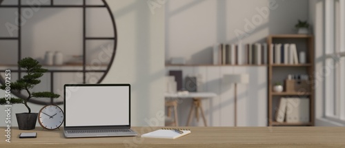 Laptop mockup, decor and copy space on wooden tabletop in minimal cozy home living room.