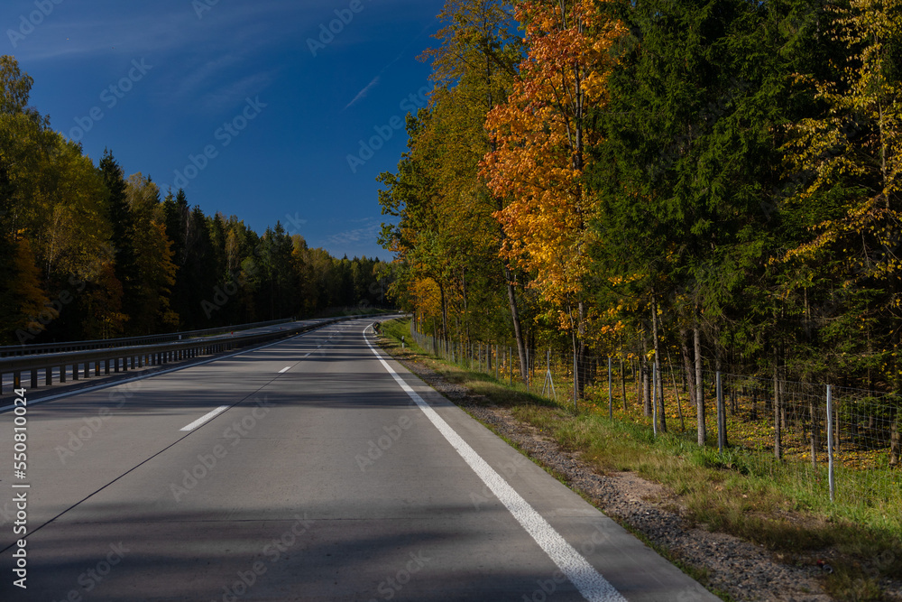Fototapeta premium Highway wide road, transport and blue sky with clouds on a summer day