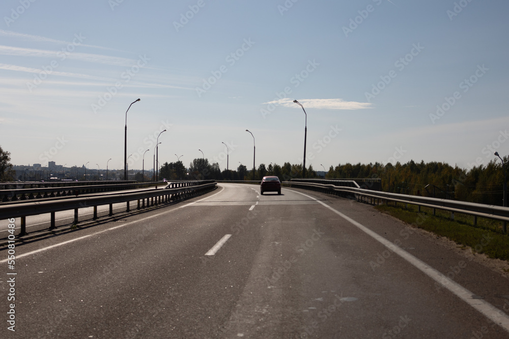 Highway wide road, transport and blue sky with clouds on a summer day