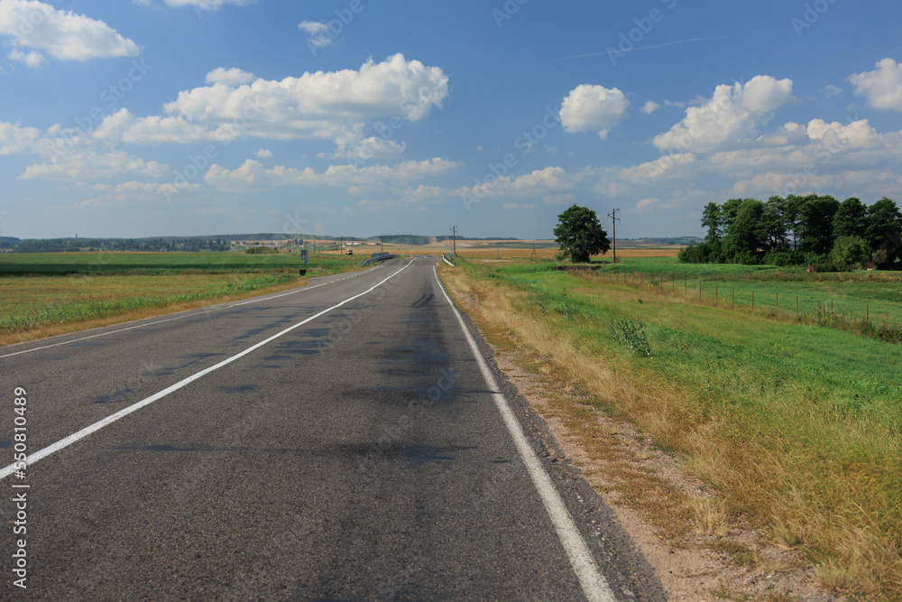 Highway wide road, transport and blue sky with clouds on a summer day Highway wide road, transport and blue sky with clouds on a summer day
