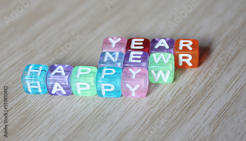 Happy New Year- word made from multicolored child toy cubes with letters