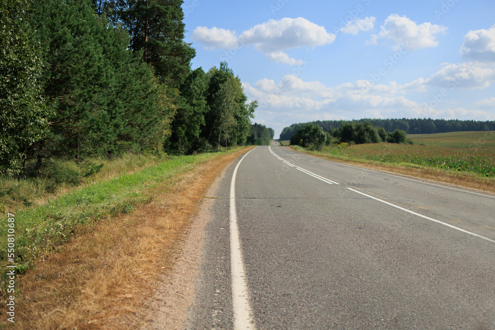 Highway wide road, transport and blue sky with clouds on a summer day