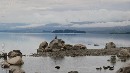 Rocks reflecting on lake Tekapo 4k photo