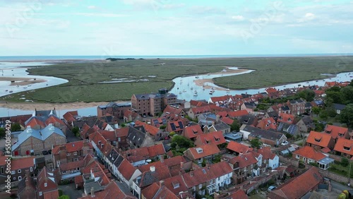 Slow ascending drone shot of Wells-Next-The-Sea town, with ships in water and shipyard visible. Drone shot. North Norfolk coast. photo